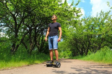 Park elektrik bir scooter sürme adam