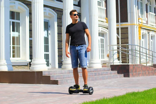 Genç adam sürme elektrikli scooter — Stok fotoğraf