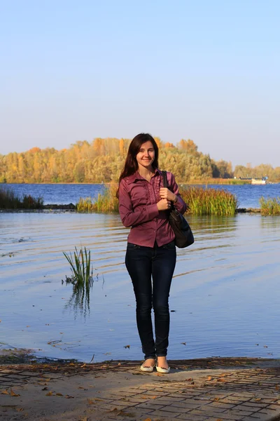 Young slender woman on the river bank — Stock Photo, Image