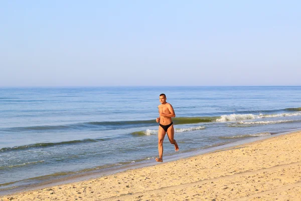 Jovem correndo na praia — Fotografia de Stock