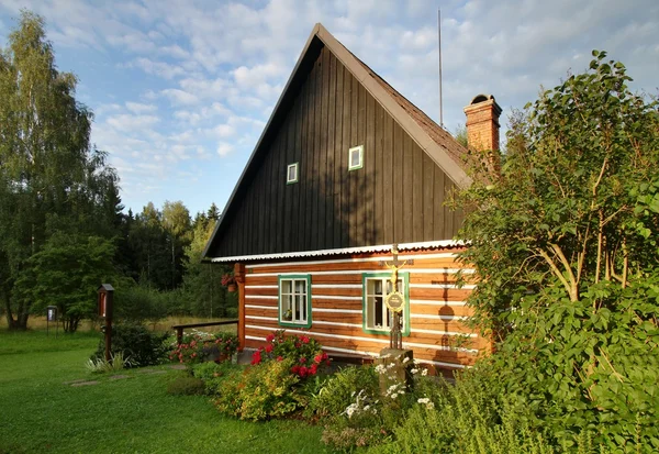 Cottage with cross — Stock Photo, Image