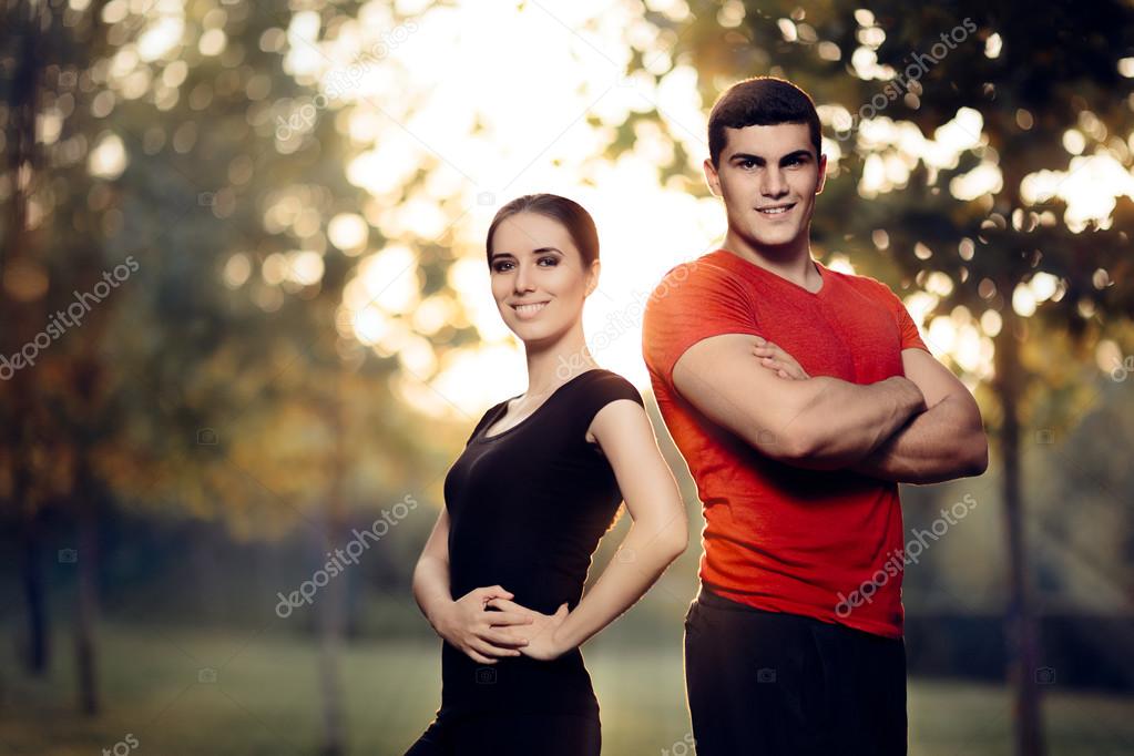 Fitness Man and Woman Standing Outside in Nature