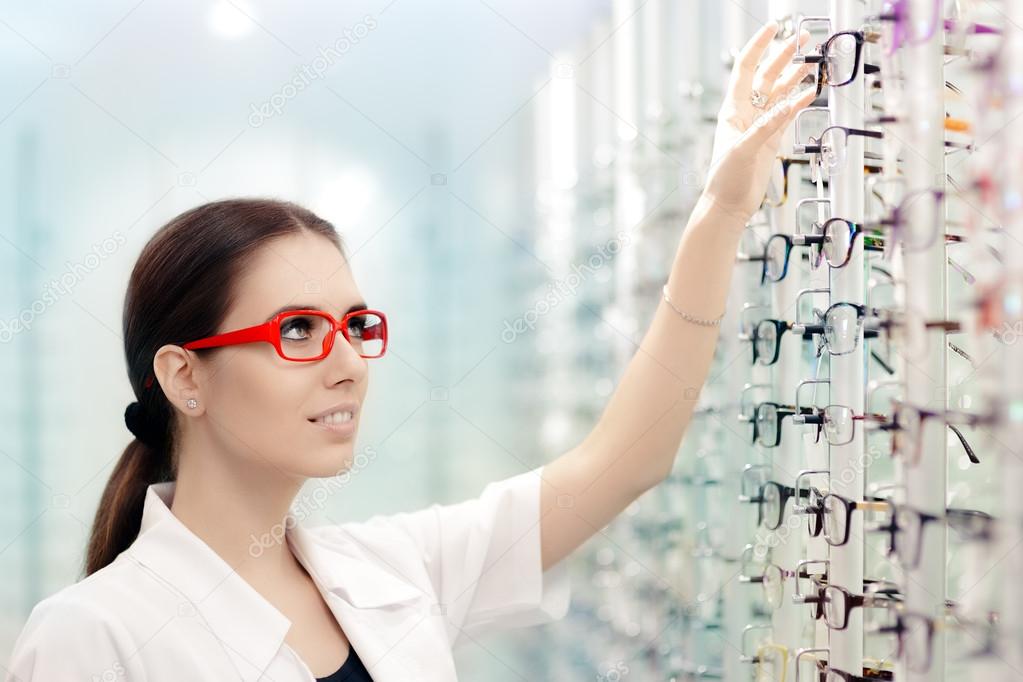 Happy Optician Choosing Between Eyeglasses Frames