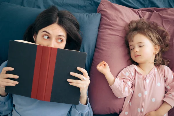 Mother Reading Bedtimes Stories to Her Baby