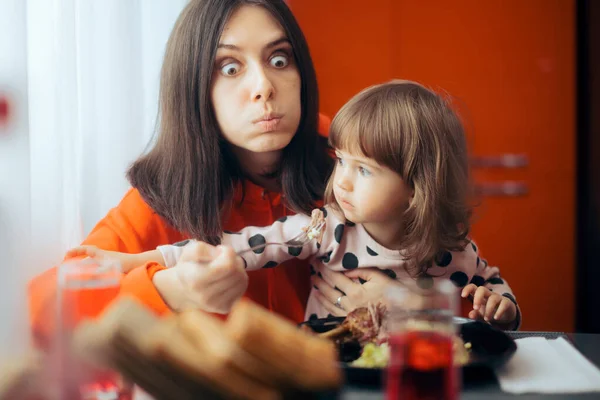 Hungry Mom Trying Eat While Child Sits Her Lap — Stok Foto