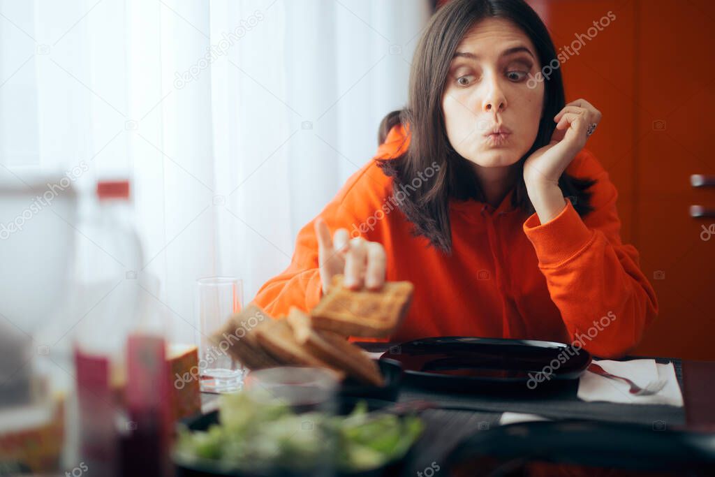 Hungry Girl Eating Bread Slice Before Dinner 