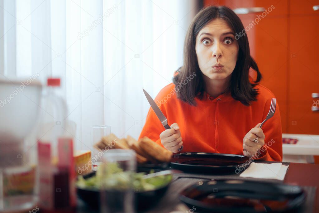 Hungry Woman Holding Fork and Knife Waiting for Dinner