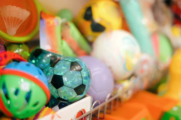 Balls Sitting on a Shelf in Toy Store