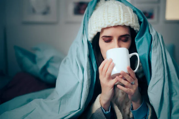 Woman Feeling Cold at Home Drinking Hot Beverage
