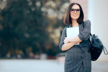 Smiling Businesswoman Holding Pc Tablet in front of Office Building
