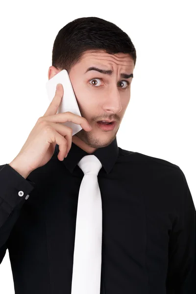 Jungunternehmer mit überraschtem Gesichtsausdruck am Telefon — Stockfoto