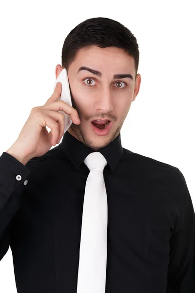 Jonge zakenman met verrast uitdrukking op de telefoon — Stockfoto