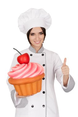 Kadın Pastane Chef Holding büyük Cupcake vererek başparmak yukarıya işareti