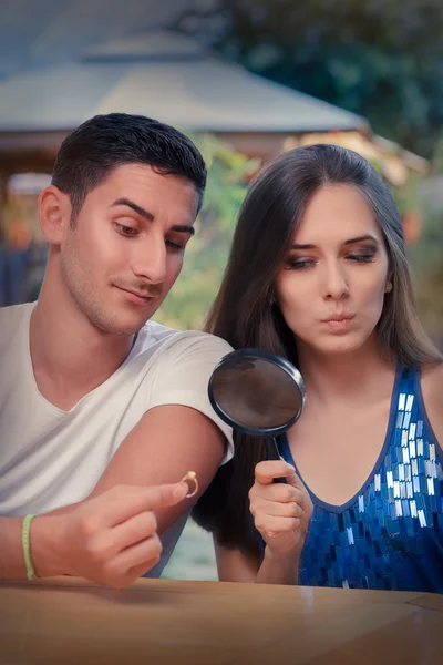 Curious Girl Testing Engagement Ring from Boyfriend with Magnifier — Stock Photo, Image