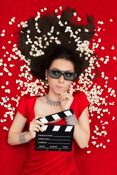 Puzzled Girl with 3D Cinema Glasses,  Popcorn and Director Clapboard — Stock Photo, Image