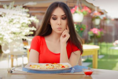 Genç kadın diyet pizza yemek hakkında düşünme