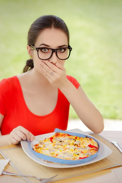 Удивлённая женщина измеряет пиццу с помощью ленты — стоковое фото