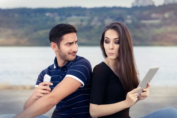 Secretive Couple with Tablet and Smartphone — Stock Photo, Image