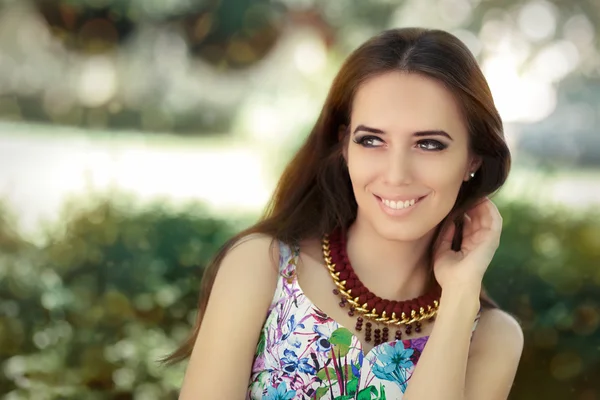 Smiling Woman Wearing Floral Dress and Big Necklace — Stockfoto