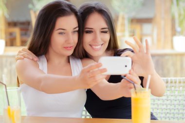 Happy Girls Taking a Selfie Together clipart