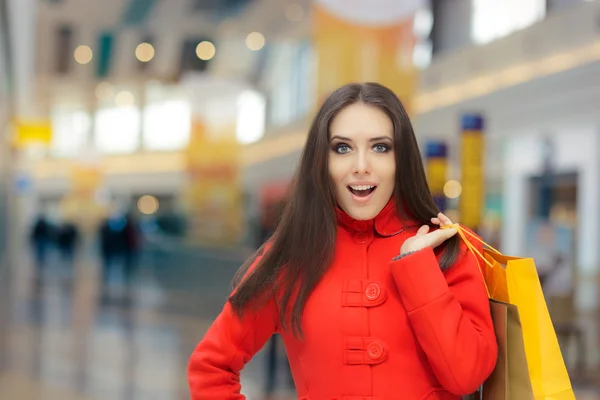 Shopping Mall Girl in a Red Coat Talking on Smartphone