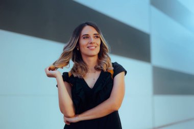 Happy Confident Woman Wearing a Black Dress Stranding Outdoors