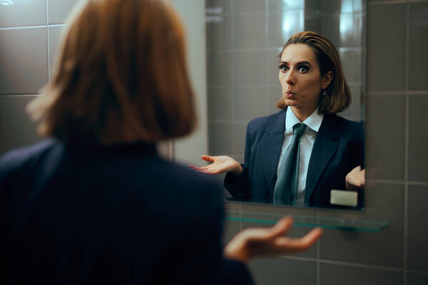 Funny Businesswoman Checking herself in the Mirror Practicing