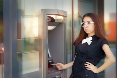 Stressed Woman with credit card at ATM clipart