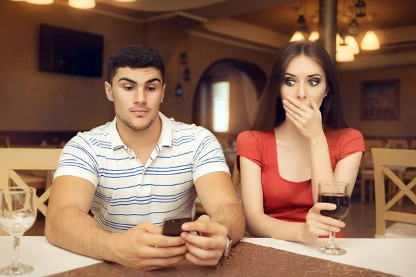 Shocked Girl Spying Boyfriend on Smartphone — Stock Photo, Image