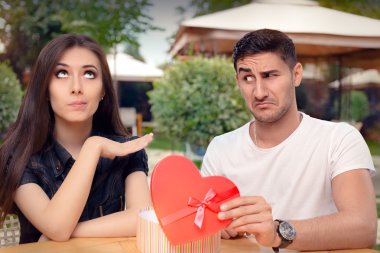 Girl Refusing Heart Shaped Gift From Her Boyfriend clipart