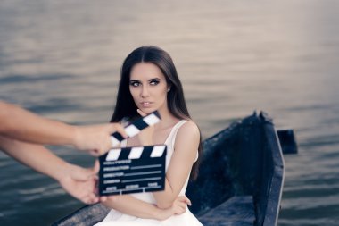 Retro Actress Shooting Movie Scene in a Boat clipart