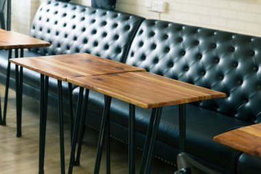 ahşap masa ve siyah deri kanepe