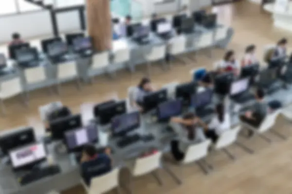 student use computer to access to internet for education (blurry
