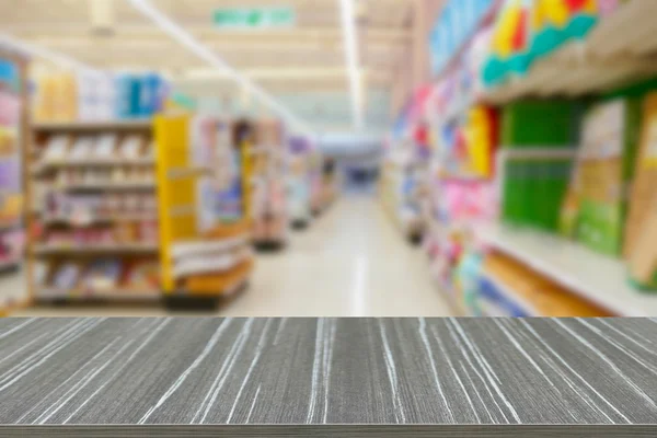 süpermarket bulanıklık b rafta mal ile boş ahşap masa