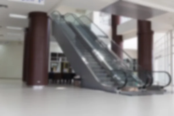 Escalator in hallway of modern building (blur background) — Stock Photo, Image
