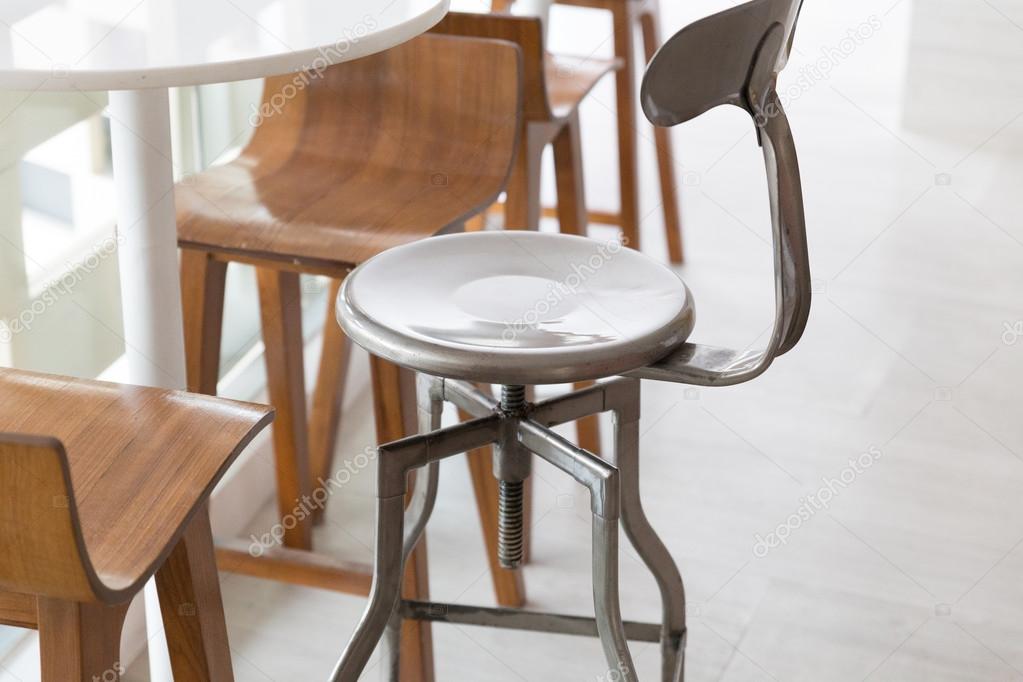 metal and wooden stool with round table at the balcony