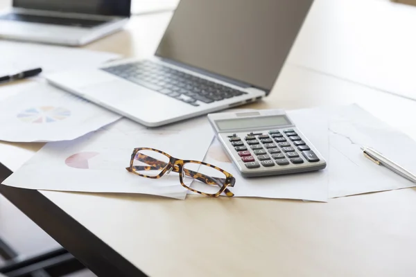 calculator, business document and computer notebook