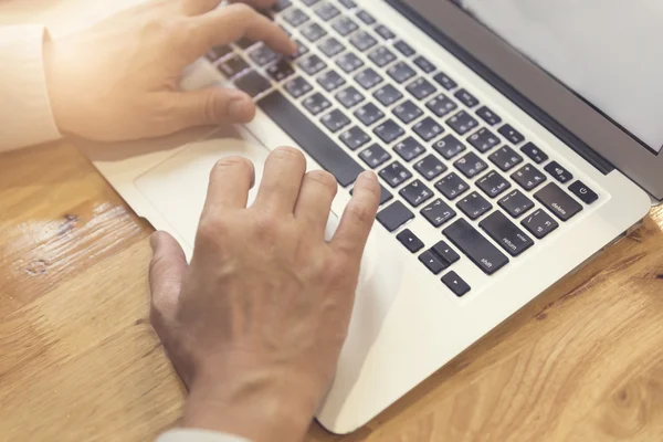 Man 's hand working with laptop computer notebook, selective focu — стоковое фото