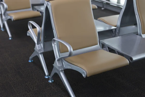 brown leather chair in airport terminal