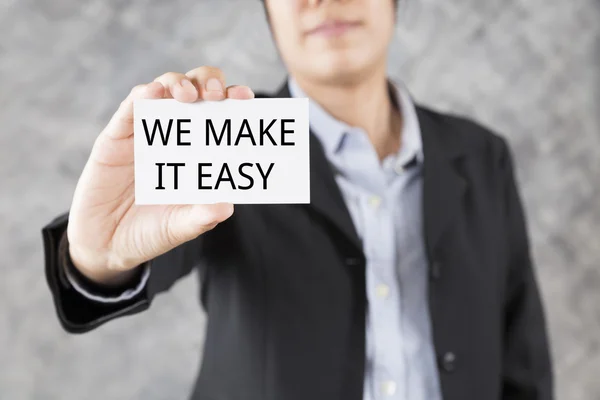 Businessman presenting business card with word we make it easy — Stock Photo, Image