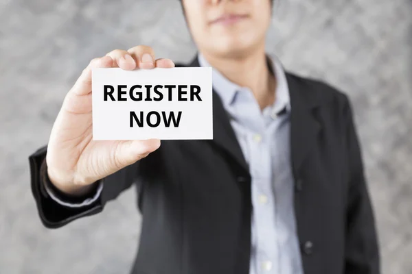 Businessman presenting business card with word register now — Stock Photo, Image