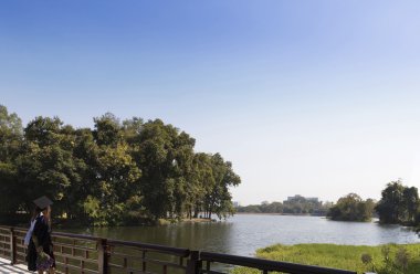 Akademik elbisesi ayakta su birikintisi genelinde köprüde kadında