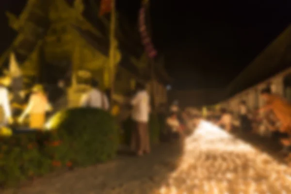 People light candle to pay respect to buddha relic - blur image