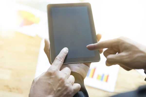 Businessman analyzing and discussing with tablet and paperwork d — Stock Photo, Image