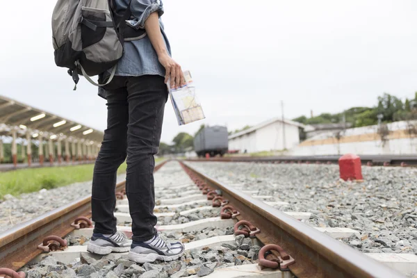 Frau hält Karte mit Rucksack am Bahnhof — Stockfoto