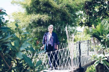 Yaşlı kadın bahçede dinleniyor. Asyalı yaşlı kadın dışarıda dinleniyor. son sınıf eğlence yaşam tarzı