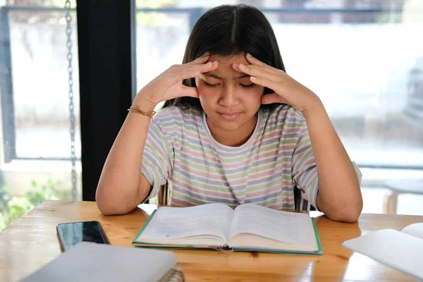 asian girl student studying hard feeling stressed tired exhausted bored. children education