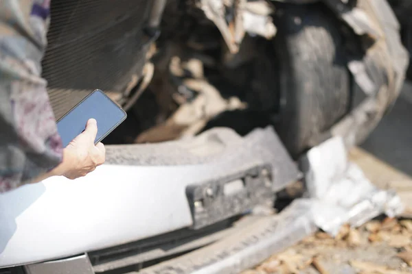 hand take photo of crashed damaged broken car. automobile crash collision accident