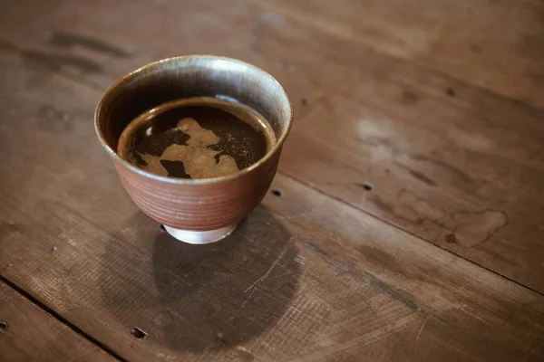 espresso cowboy coffee in ceramic cup on wooden table