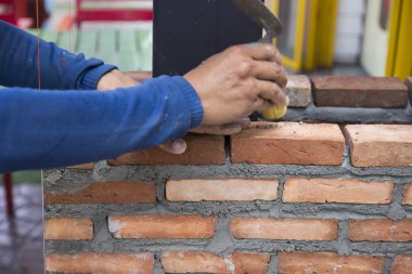 the worker is masoning the brick clipart